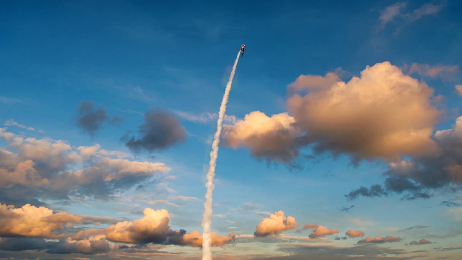 A Rocketman climbing into a blue sky, trailing white smoke